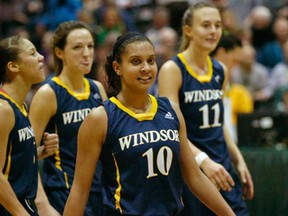 Lancers guard Miah-Marie Langlois, centre, smiles toward her bench in the dying seconds of the CIS women's basketball final against the host Cougars in Regina, Sask., Sunday March 17, 2013. The Lancers sealed their third straight national title with a 66-57 victory. (Michael Bell/Leader-Post)