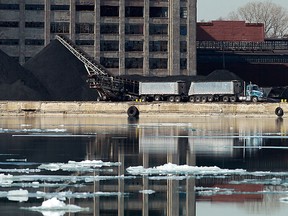 Piles of petroleum coke are seen from Windsor on the banks of the Detroit River in Detroit on March 8, 2013. (TYLER BROWNBRIDGE/The Windsor Star)