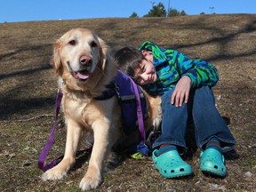 Gabriel D'Annunzio, who suffers from autism, is pictured with his service dog, Indiana, before the start of the National Service Dogs Annual Easter Egg Hunt at Malden Park, Friday, March 29, 2013.  (DAX MELMER/The Windsor Star)