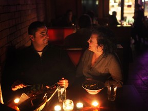 WINDSOR, ONT.:MARCH 23, 2013 -- Cal Stagno, left, and Amanda Malkowski, enjoy a dinner in the dark while at Chanoso's and Oishii as the restaurant turned out the lights for Earth Hour, Saturday, March 23, 2013.  (DAX MELMER/The Windsor Star)