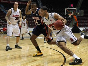Windsor's Anthony Johnson, right. drives to the basket against Summerside's Louis Birdsong during regular season action at the WFCU Centre. The Express rallied to beat the Storm Sunday in their playoff opener. (DAX MELMER/The Windsor Star)