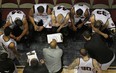 Windsor Express head coach Bill Jones, centre, talks to his team during a regular season game against Summerside at the WFCU Centre. The Express rallied to beat the Storm 114-112 Sunday in their playoff opener. (DAX MELMER/The Windsor Star)