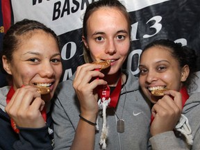 University of Windsor Lancers, Korissa Williams (L), Jessica Clemencon (C) and Miah-Marie Langlois pose with their CIS women's basketball championship medals Monday, March 18, 2013, after arriving at the Windsor, Ont. campus.  (DAN JANISSE/The Windsor Star