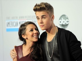 In this Nov. 18, 2012 file photo, Justin Bieber, right, and Pattie Mallette arrive at the 40th Anniversary American Music Awards, in Los Angeles. (Photo by Jordan Strauss/Invision/AP, File)