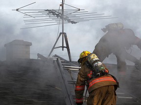 ESSEX, ONT.:MARCH 9, 2013 -- Fire fighters with the Essex Fire Department tend to a house fire at 14013 Walker Road, Saturday, March 9, 2013. No injuries were reported. (DAX MELMER/The Windsor Star)