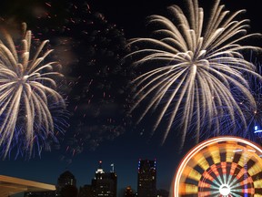 In this file photo, the lights of the ferris wheel shine while the Target Fireworks explode in the background Monday, June 25, 2012. (DAX MELMER/The Windsor Star)