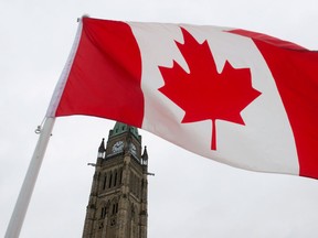 A Canadian flag flies on Parliament Hill Friday February 15, 2013 in Ottawa. (THE CANADIAN PRESS/Adrian Wyld)
