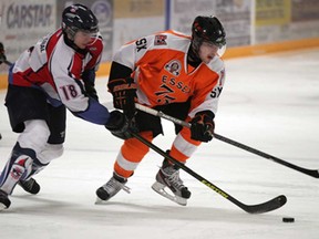 Matthew Hebert, right, of the Essex 73's shields the puck from Wheatley's Austin Fontaine, left, in Game 1 of the Junior C final from Essex Arena Tuesday March 5, 2013. The 73's won 5-1. (NICK BRANCACCIO/The Windsor Star)