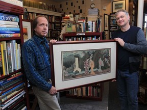 Mark Reesman, left,  and Roger Wurdeman owner of Juniper Books, hold a Japanese woodblock print called Geshas Strolling Among the Waterfalls, at the book store on Ottawa Street in Windsor. (JASON KRYK / The Windsor Star)