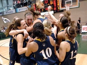 The Windsor Lancers celebrate their third straight national title after beating Regina 66-57 in the CIS women's basketball championship final at the University of Regina in Regina, Sask. Sunday March 17, 2013.  (Michael Bell/Leader-Post)