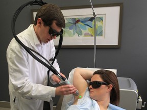Dermatologist Dr. Dan Radin uses the Gentlemax Pro Laser to remove hair from patient Brooke Waters at his office in Tecumseh.  (JASON KRYK / The Windsor Star)