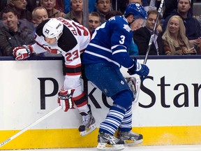 New Jersey's David Clarkson, left, gets hammered into the boards by Toronto's Dion Phaneuf (3) during NHL action in Toronto Monday March 4, 2013. (THE CANADIAN PRESS/Frank Gunn)