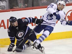 Jets forward Bryan Little, left, and Toronto's Nazem Kadri get tied up during first period action on March 12, 2013 at the MTS Centre in Winnipeg, Manitoba, Canada. (Photo by Marianne Helm/Getty Images)