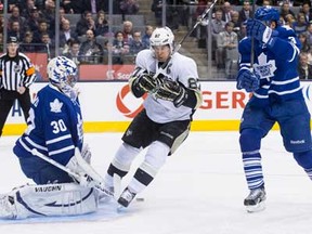 Penguins captain Sidney Crosby, centre, skates in in front of Maple Leafs goaltender Ben Scrivens, left, as Dion Phaneuf defends during the first period in Toronto on Thursday March 14, 2013. (THE CANADIAN PRESS/Chris Young)