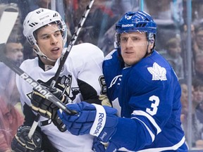 Toronto's Dion Phaneuf, right, battles Pittsburgh's Sidney Crosby in Toronto Saturday, March 9, 2013.The Penguins won 5-4 in a shootout. (THE CANADIAN PRESS/Chris Young)
