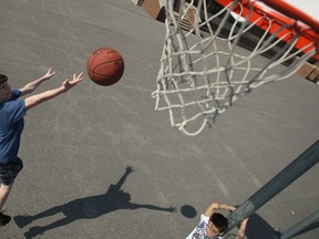 In this file photo, Justing Johnston, left, and Austin Thornton  play basketball at Hugh Beaton Public School in Windsor, Ont. on March 13, 2012. (Dax Melmer / The Windsor Star)