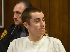 T.J. Lane smirks as he listens to the judge during sentencing Tuesday, March 19, 2013, in Chardon, Ohio. Lane, was given three lifetime prison sentences without the possibility of parole Tuesday for opening fire last year in a high school cafeteria in a rampage that left three students dead and three others wounded. Lane, 18, had pleaded guilty last month to shooting at students in February 2012 at Chardon High School, east of Cleveland. Investigators have said he admitted to the shooting but said he didn't know why he did it. Before the case went to adult court last year, a juvenile court judge ruled that Lane was mentally competent to stand trial despite evidence he suffers from hallucinations, psychosis and fantasies. (AP Photo/The News-Herald, Duncan Scott, Pool)