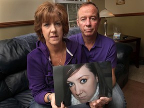 Marc and Patti Praill hold a photo of their daughter Pam, Friday, March 15, 2013, at their Harrow, Ont. home. Pam died Dec. 24, 2012, after suffering a medical emergency while on a shopping outing in Michigan. The parents chose to donate several of their daughters organs to help others. (DAN JANISSE/The Windsor Star)