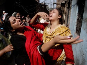 Pakistani Christian women wail after visiting their homes which were damaged by an angry Muslim mob in Lahore, Pakistan, March 10, 2013. (Associated Press/K.M. Chaudary)
