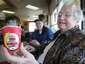Mary Graham, 87, shows her winning Tim Hortons cup with her husband Claude Graham, 89, Tuesday, March 26, 2013, at the Walker and North Talbot Rd location in Windsor, Ont. (DAN JANISSE/The Windsor Star)
