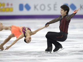 Wenjing Sui and Cong Han competing for China perform during Pairs Short Program at the 2013 World Figure Skating Championships in London, Ontario, Canada, March 13, 2013. Skaters from around the globe are competing in the four day event to become the world champions in mens, ladies, pairs and ice dance figure skating.  AFP PHOTO/BRENDAN SMIALOWSKI/Getty Images