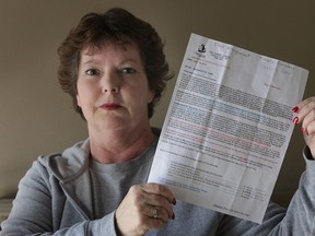 Windsor resident Bernadette Carr, 53, shows some of the mail she received in a "secret shopper" scam. Carr lost $3,200 to a fraudster as a result of the scheme. Photographed Mar. 6, 2013. (Dan Janisse / The Windsor Star)