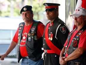 File: Canadian military veterans Bob Papak, left, Windsor Police Senior Const. Mike Akpata and Mike Lepine, at the unveiling of Portraits of Honour mural which included a portrait of Windsor's Cpl. Andrew Grenon on June 30, 2011.  (Windsor Star files)