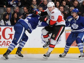 Ottawa's Zack Smith, centre, jumps between Toronto's Mark Fraser and Tyler Bozak during NHL action March 6, 2013 at the Air Canada Centre in Toronto. (Abelimages/Getty Images)