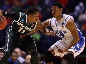 Michigan State's Keith Appling, left, looks to drive the ball against Duke's Quinn Cook during the Midwest Region Semifinal round of the 2013 NCAA Men's Basketball Tournament at Lucas Oil Stadium on March 29, 2013 in Indianapolis, Indiana.  (Photo by Streeter Lecka/Getty Images)