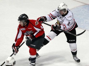 Spitfires forward Alex Aleardi, left, battles Owen Sound defenceman Keevin Cutting in OHL action at the WFCU Centre, Thursday March 14, 2013. (NICK BRANCACCIO/The Windsor Star)