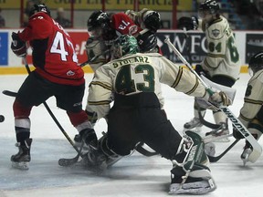 Windsor's Alex Aleardi, left, and Remy Giftopoulos battle in front of the London net as the puck sails into the net past London goalie, Anthony Stolarz during OHL action at the WFCU Centre, Sunday, March 10, 2013. The Spits won 8-1. (DAX MELMER/The Windsor Star)