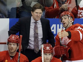 Detroit Red Wings left wing Drew Miller (20) talks with coach Mike Babcock during the second period of an NHL hockey game against the Dallas Stars in Detroit, Tuesday, Jan. 22, 2013. (AP Photo/Carlos Osorio)
