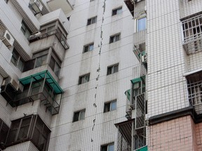 A large crack lines the entire exterior wall of a building in Taichung, central Taiwan, Wednesday, March 27, 2013, following a strong earthquake early in the day. The 6.1 quake struck central Taiwan on Wednesday, killing at least one person and injuring 19 as it damaged buildings on the quake-prone island. (AP Photo)