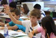 Kevin Siddall raises his hand during class  on Sept. 14, 2011, at Christ the King School in Windsor. The Windsor-Essex Catholic School Board held a media conference at the school to announce the EQAO results. (Windsor Star files)