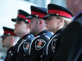 Windsor police constables stand at attention with other officers honoured in this 2012 file photo. (JASON KRYK/The Windsor Star)