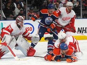 Edmonton's Teemu Hartikainen, bottom right, battles for position against Detroit's Jakub Kindl on March 15 2013 at Rexall Place in Edmonton, Alberta, Canada. (Photo by Andy Devlin/NHLI via Getty Images)