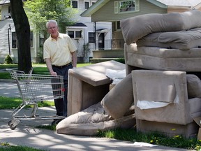 Randolph Avenue resident Fred Plexman surveys the mountains of old furniture and garbage left by University of Windsor students in this May 2007 file photo. (NICK BRANCACCIO/The Windsor Star)