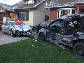 The scene of an early morning crash Saturday, in which a stolen vehicle hit a stop sign and several parked cars. (Katherine Simpson for The Windsor Star)