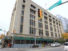 Scaffolding has surrounded the Paul Martin building at the corner of Ouellette Avenue and Pitt Street in Windsor, Ont. for more than three years, but it has nothing to do with the work that's required on the aging structure. The scaffolding is there to keep falling bricks from landing on the heads of passing pedestrians. (Windsor Star files)