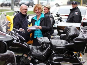 Survivor Dennis Solet, 64, left, and Windsor Telus Motorcycle Ride for Dad chair Sue Garrett check out some of the sweet rides as Windsor Police officers Diane Donnelly and Frank Bauer, behind, join the fun at Walkerville Brewery kickoff event Thursday April 25, 2013.   (NICK BRANCACCIO/The Windsor Star)