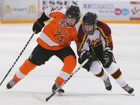 Daniel McIntyre, left, of the Essex 73's is checked by Grimsby's Dalton Procyshn.                  (TYLER BROWNBRIDGE/The Windsor Star)