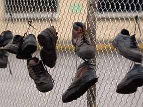 Workers' shoes hang on the fence at the closed National Auto Radiator plant on Airport Road in Windsor. (NICK BRANCACCIO/The Windsor Star)
