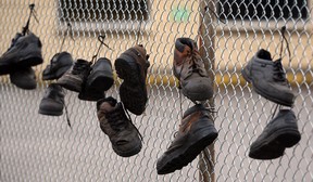 Workers' shoes hang on the fence at the closed National Auto Radiator plant on Airport Road in Windsor. (NICK BRANCACCIO/The Windsor Star)