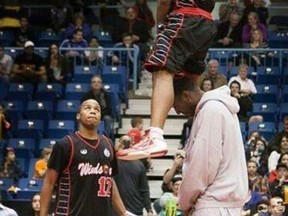 Express guard Stefan Bonneau, centre, dunks over Chris Commons at the NBL of Canada dunk contest Saturday in Saint John, N.B.