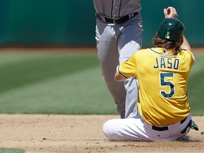 Detroit second baseman Omar Infante, top, throws over Oakland's John Jaso in the third inning Sunday in Oakland. (AP Photo/Ben Margot)