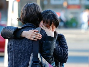 Boston University students hug each other following a Service of Healing on April 17, 2013 for BU graduate student Lu Lingzi, who was killed during the bomb explosions near the finish line of the Boston Marathon. (Jared Wickerham/Getty Images)