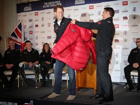 Prince Harry (centre L) is presented with a jacket by Inge Solheim as he attends the launch for Walking with the Wounded South Pole Allied challenge at the Mandarin Oriental Hyde Park on April 19, 2013 in London, England.  (Photo by Chris Jackson/Getty Images)