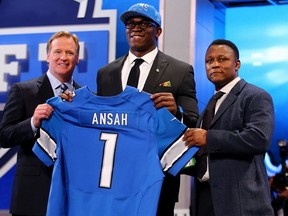 Ezekiel Ansah of the BYU Cougars stands with NFL Commissioner Roger Goodell (L) and Pro Football Hall of Famer Barry Sanders (R) as they hold up a jersey on stage after Ansah was picked #5 overall by the Detroit Lions in the first round of the 2013 NFL Draft at Radio City Music Hall on April 25, 2013 in New York City.  (Photo by Al Bello/Getty Images)
