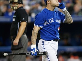 Toronto's Brett Lawrie, right, strikes out in the fourth inning against the Chicago White Sox. (Photo by Tom Szczerbowski/Getty Images)