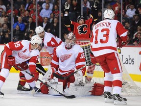 Calgary's Lee Stempniak, right, scores a goal against Jimmy Howard of the Red Wings at the Scotiabank Saddledome Wednesday. (Photo by Derek Leung/Getty Images)